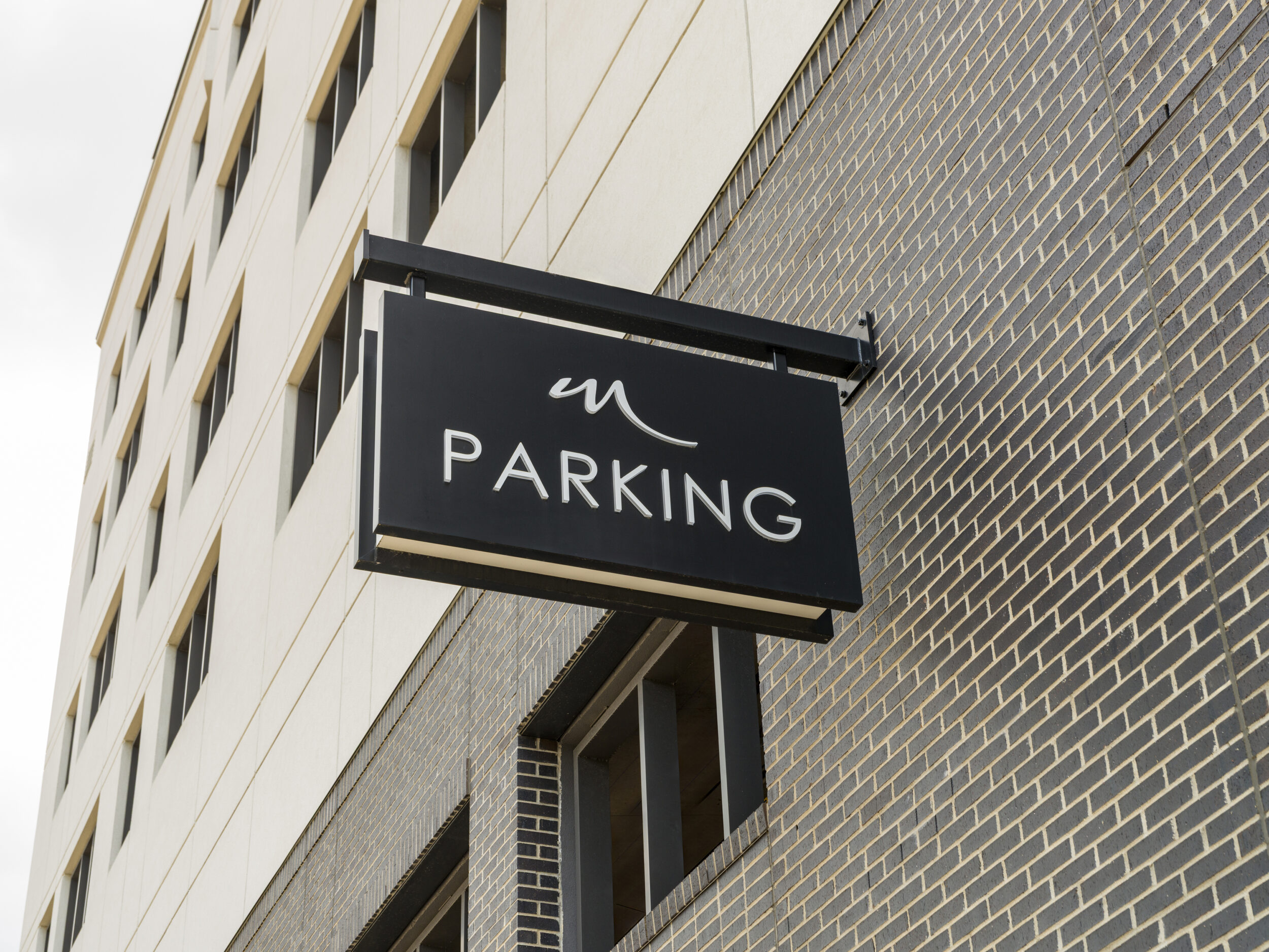 Parking sign on exterior of building