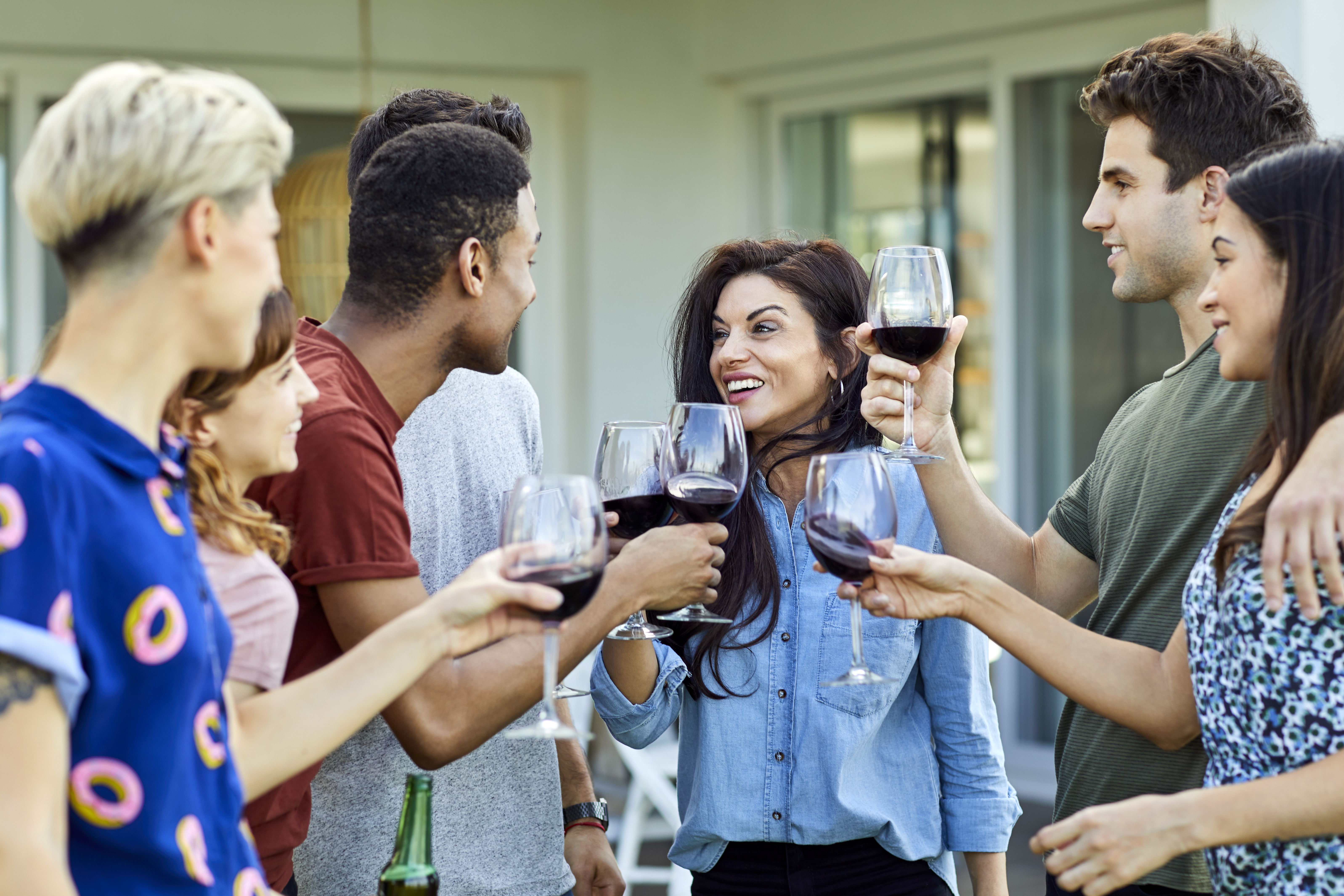 Friends enjoying wine in backyard